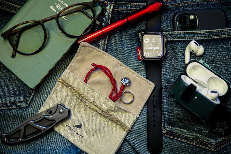 EDC pocket knife and daily carry items on denim