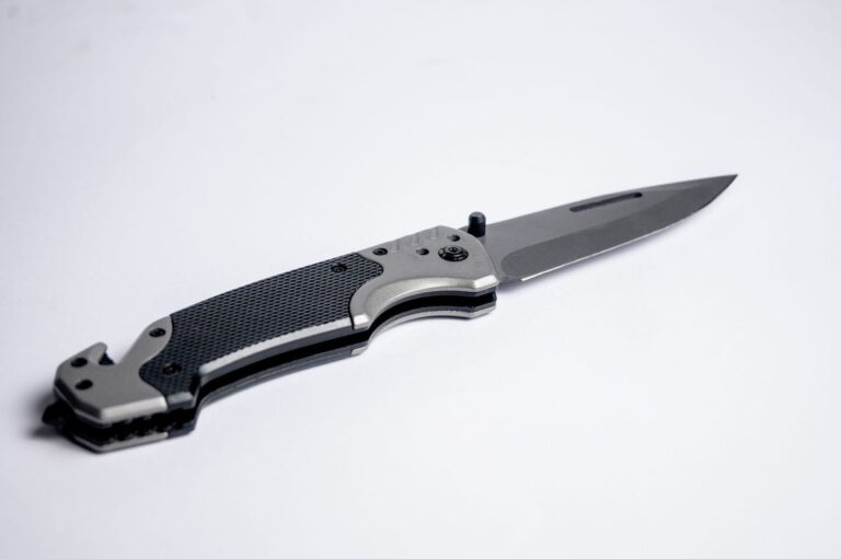 Tactical-style folding EDC knife opened on a white studio background
