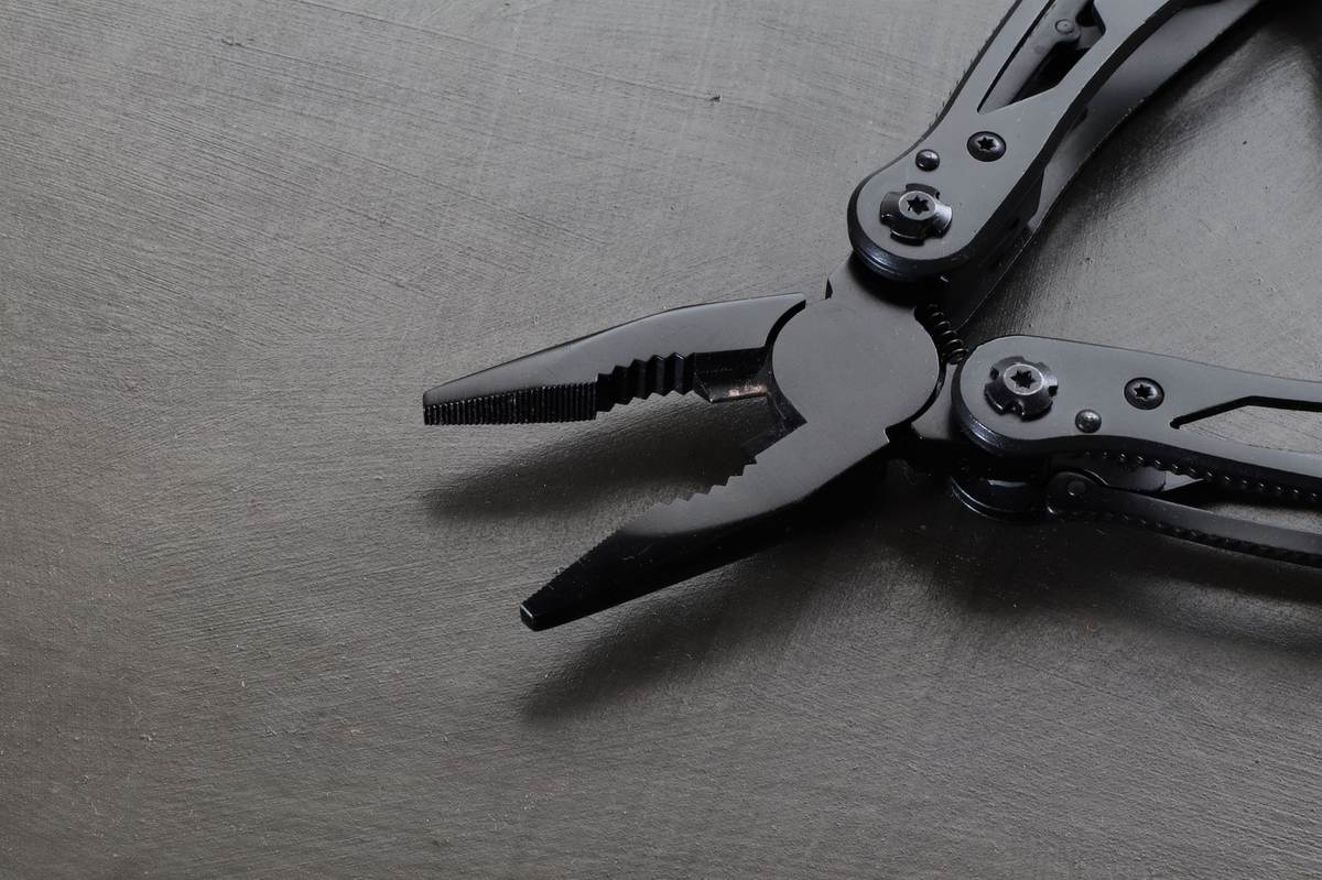 Macro shot of a flagship black EDC multitool's pliers mechanism