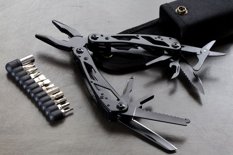 Full-size plier multitool opened with bit driver set and belt sheath