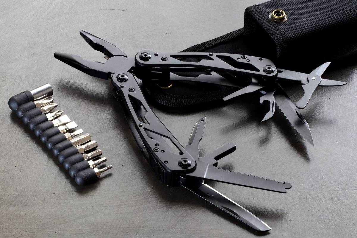 Full-size plier multitool opened with bit driver set and belt sheath