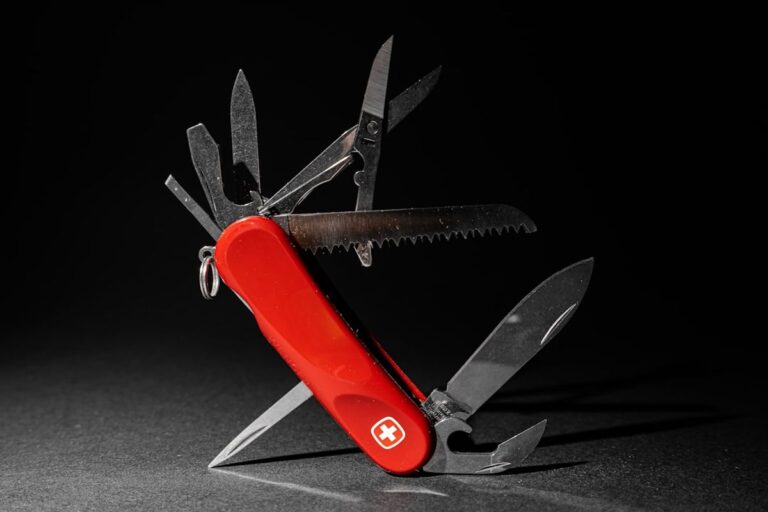 Multitool opened to show scissors, knife blade, and saw attachments