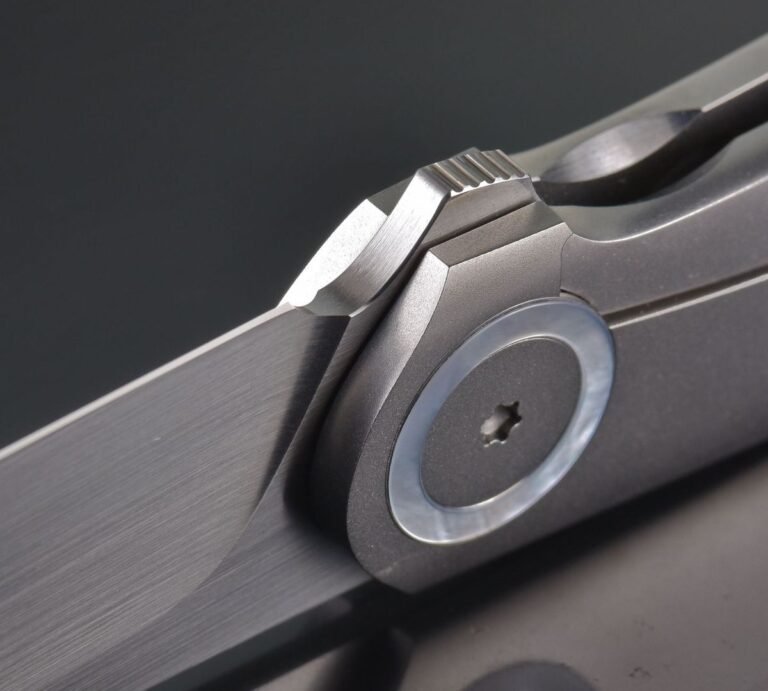 Macro close-up of a pocket knife's pivot and blade detent mechanism