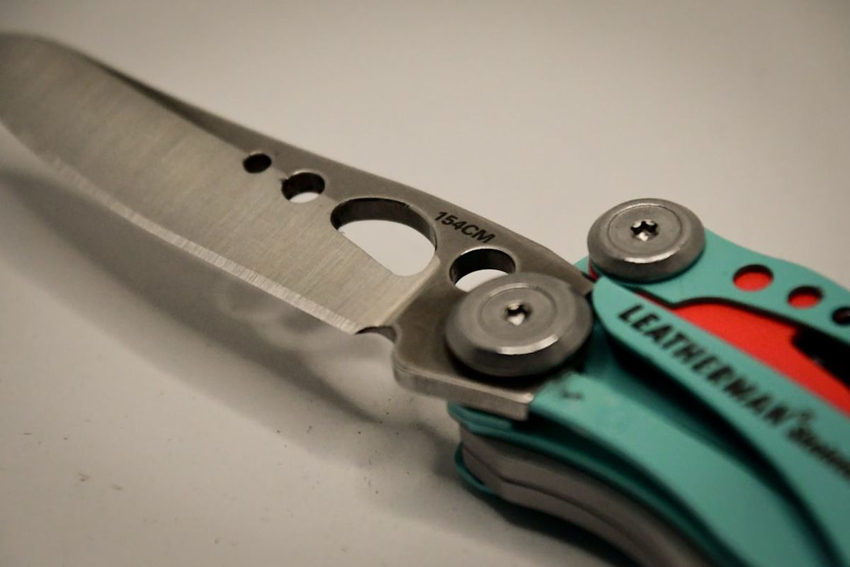 Close-up of a compact keychain-class multitool blade and pivot mechanism