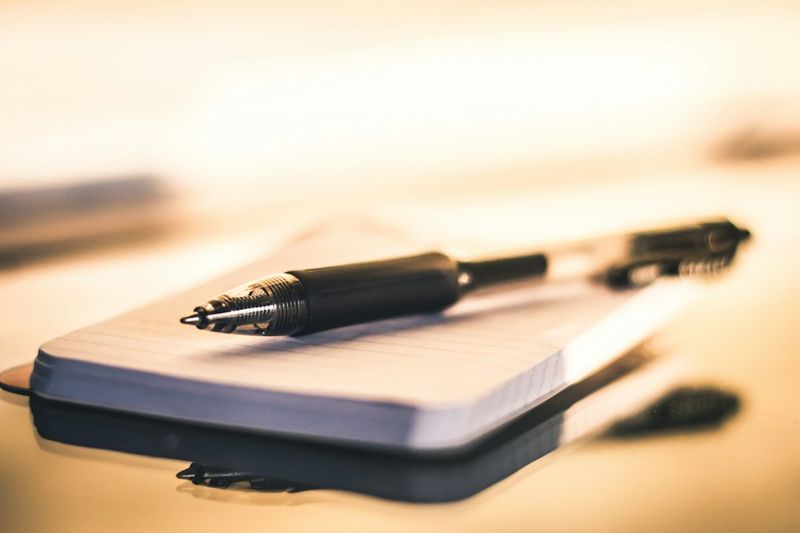 Click-action ballpoint pen on a notepad used for nurse charting