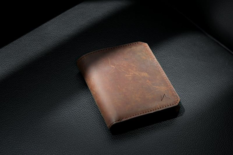 Minimalist bifold wallet in leather showing reduced card capacity for EDC