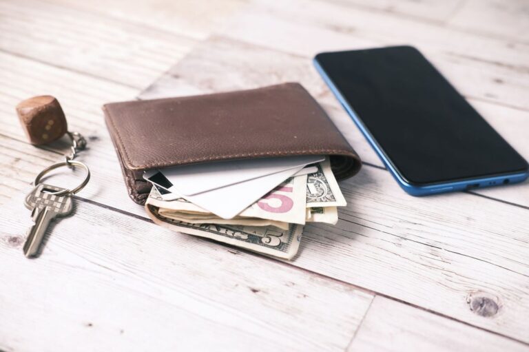 Commuter EDC essentials laid out: wallet, keys, and phone