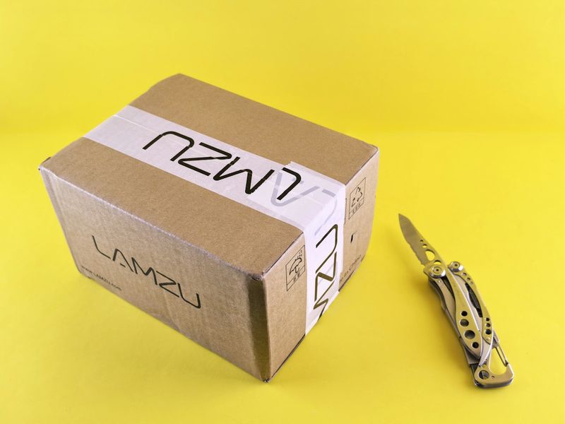 box cutter opening a cardboard delivery package