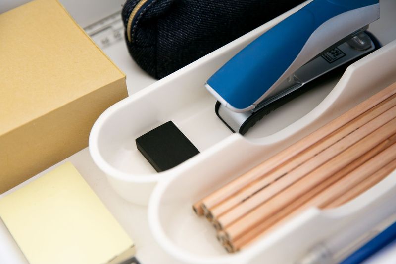 Organized desk drawer storing an EDC first aid kit at the office