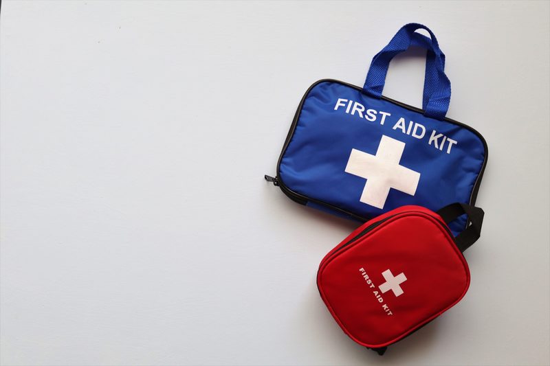 Compact first aid kits on a white background representing the one category not to cut from minimalist EDC
