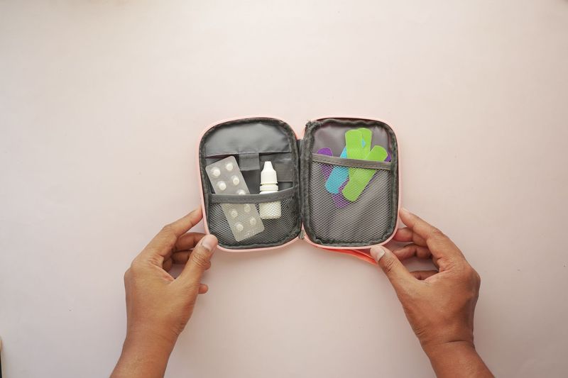 Open EDC first aid kit pouch showing bandages and medication inside