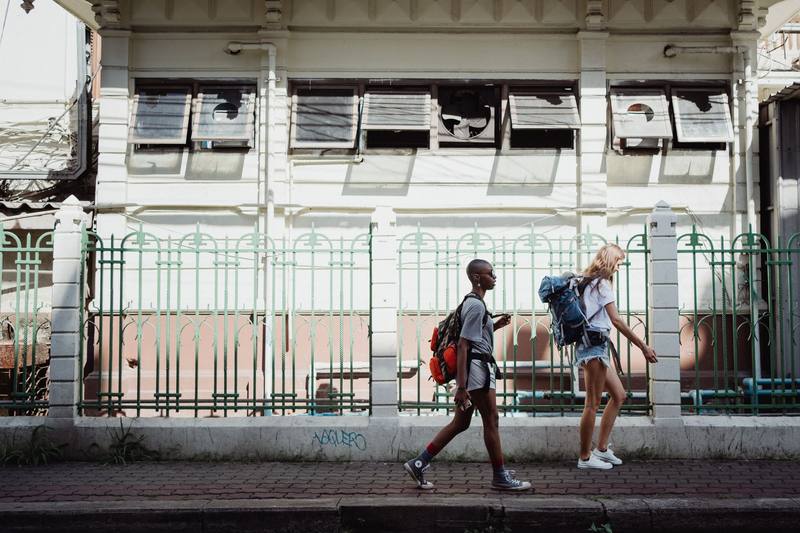 Commuters walking a city sidewalk where an EDC first aid kit gets used