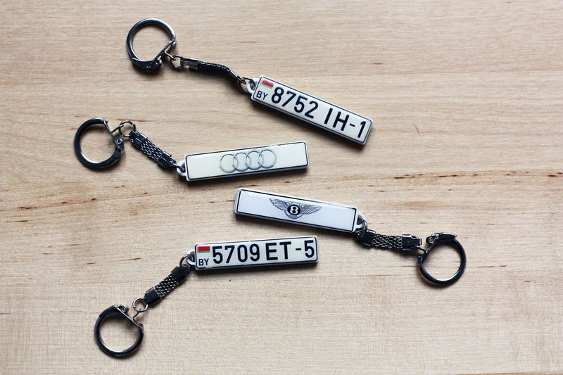Metal EDC keychains on a light wood desk