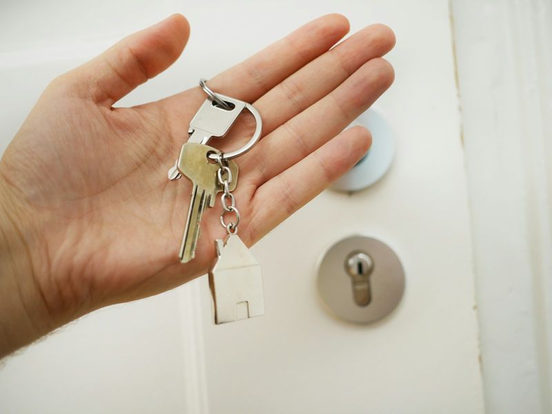 Hand holding fanned out keys from an EDC key organizer