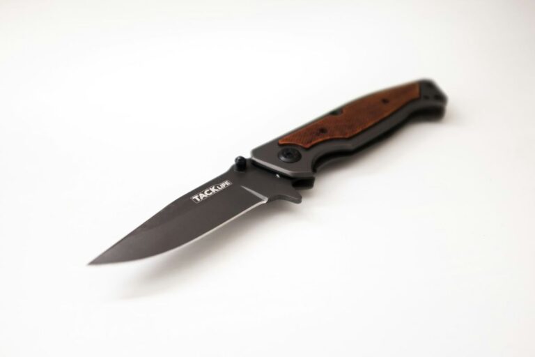 EDC pocket knife with open blade on a light background, representing US knife carry laws