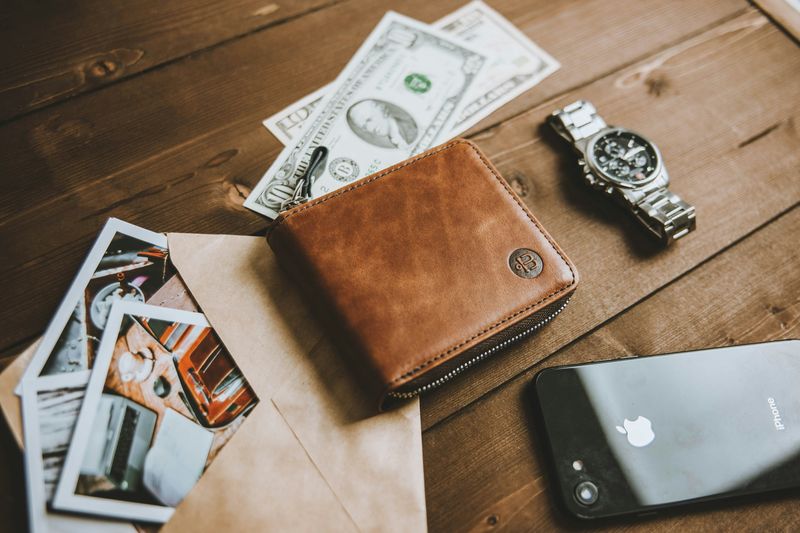 wallet and phone representing edc sling bag price tiers