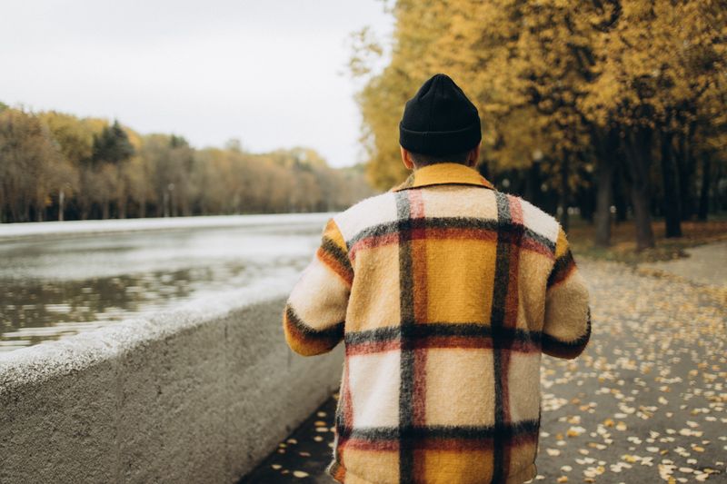 layering edc gear across jacket pockets while walking in fall weather