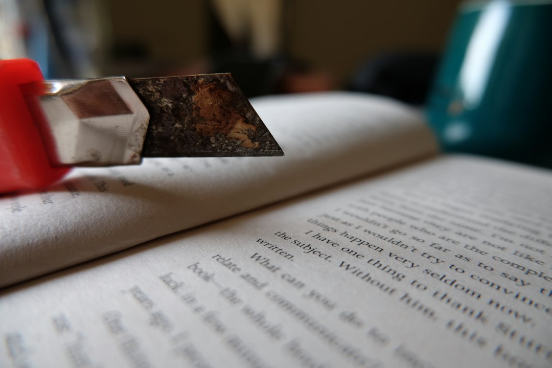 Close-up of a utility knife over an open book