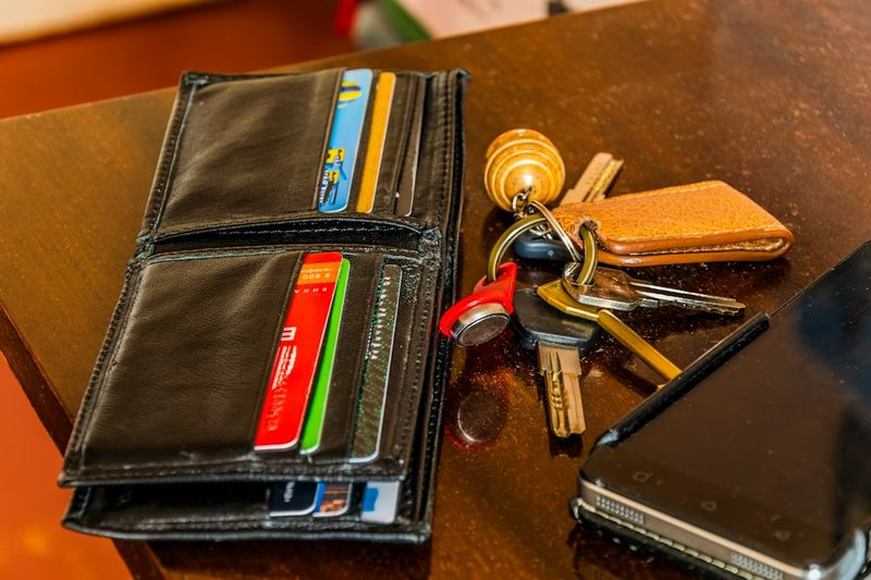 office edc wallet keys and pen laid out on a desk