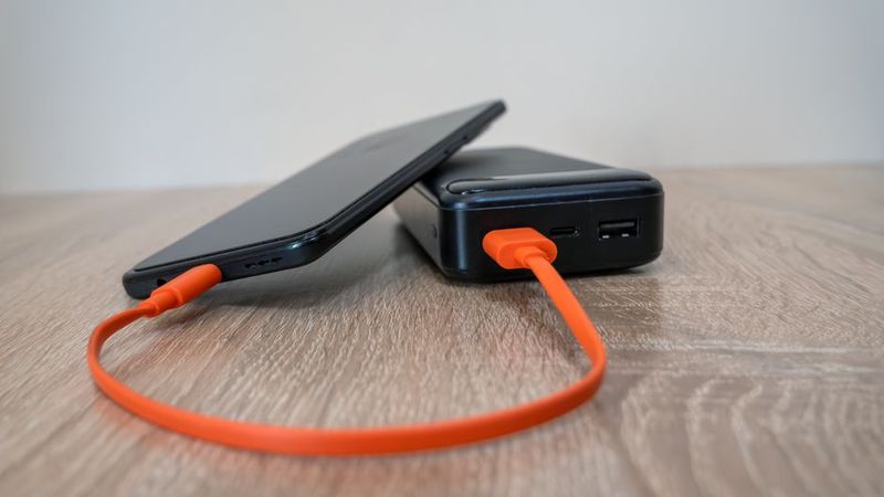 power bank charging a phone for rideshare driver backup power