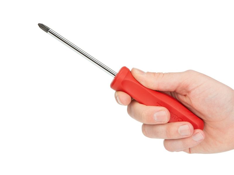 Small blade-free desk tool with screwdriver tip on a classroom desk