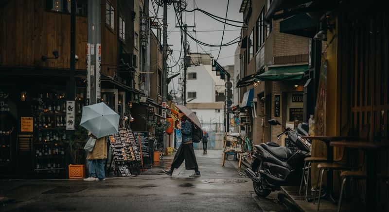 Commuters walking with umbrellas in the rain
