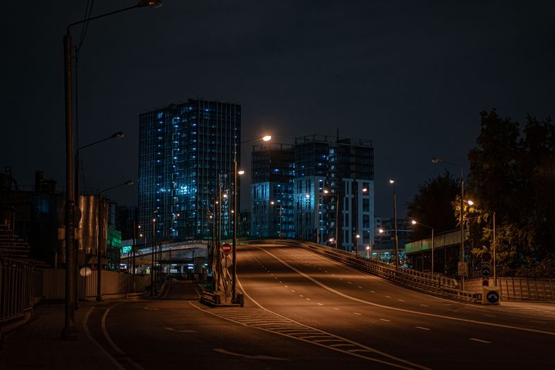 dark urban street at night showing need for EDC flashlight in winter