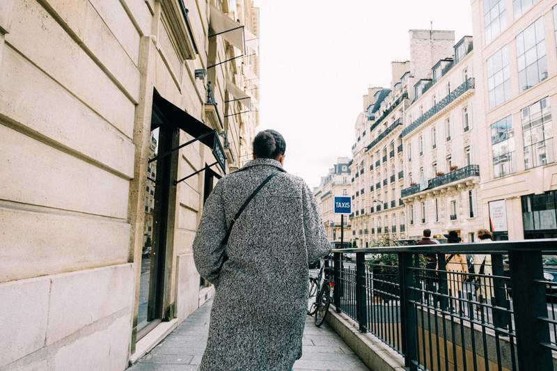 man walking in winter coat on urban city street